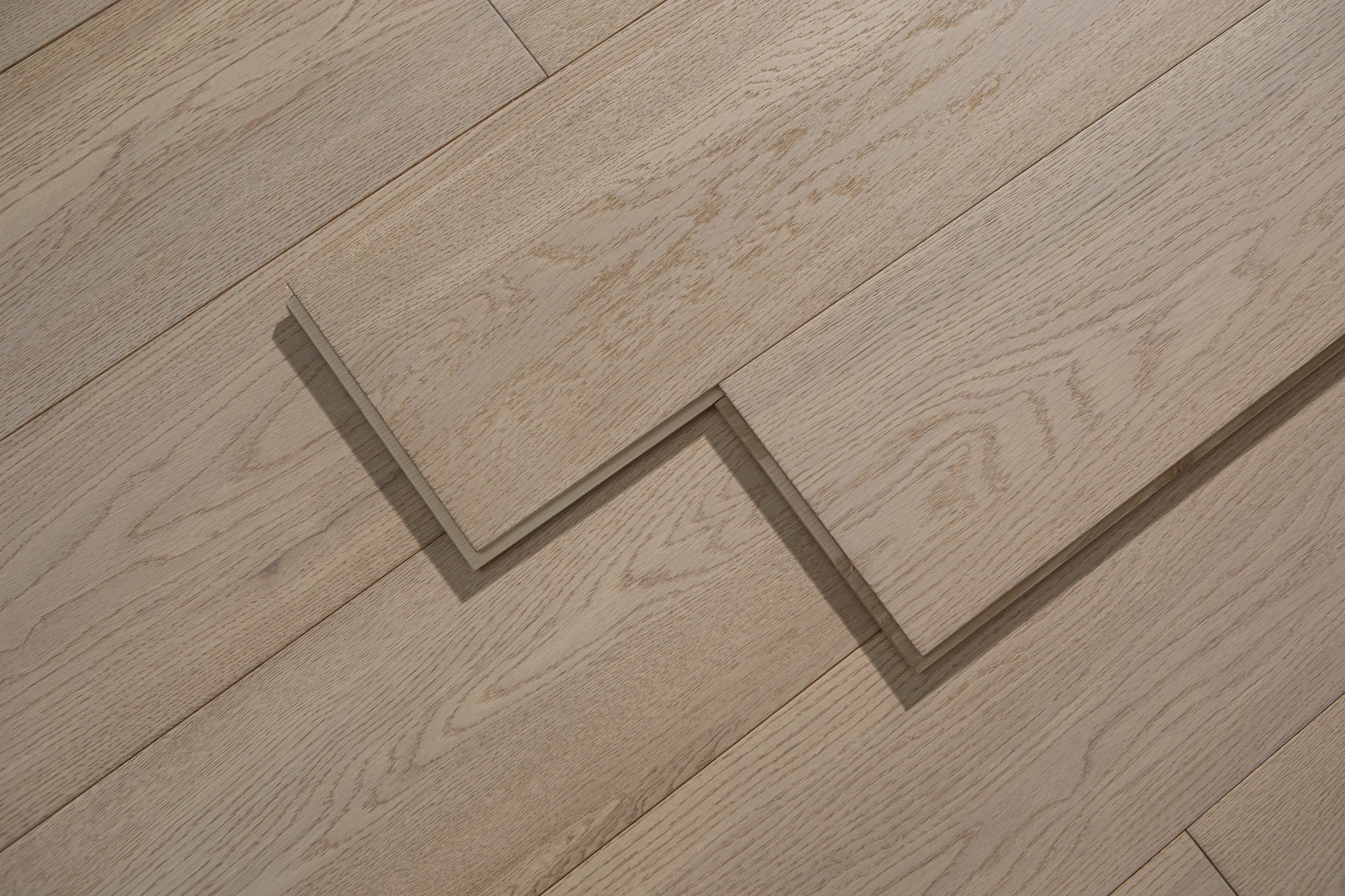 Stacked oak flooring boards showing their surface and edge profile